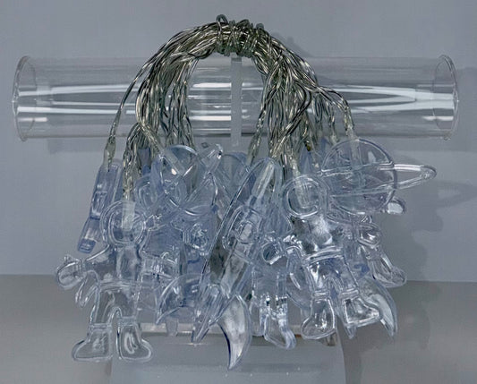 Clear plastic Christmas ornaments shaped like animals, hanging from a bundle of silver wire lights, displayed in front of a clear cylindrical stand against a light gray background.