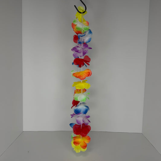 A vertical plastic flower lei garland with a black hanging loop at the top, featuring multiple colors of faux hibiscus-style flowers including red, yellow, orange, purple, blue, and green, set against a plain light gray background.