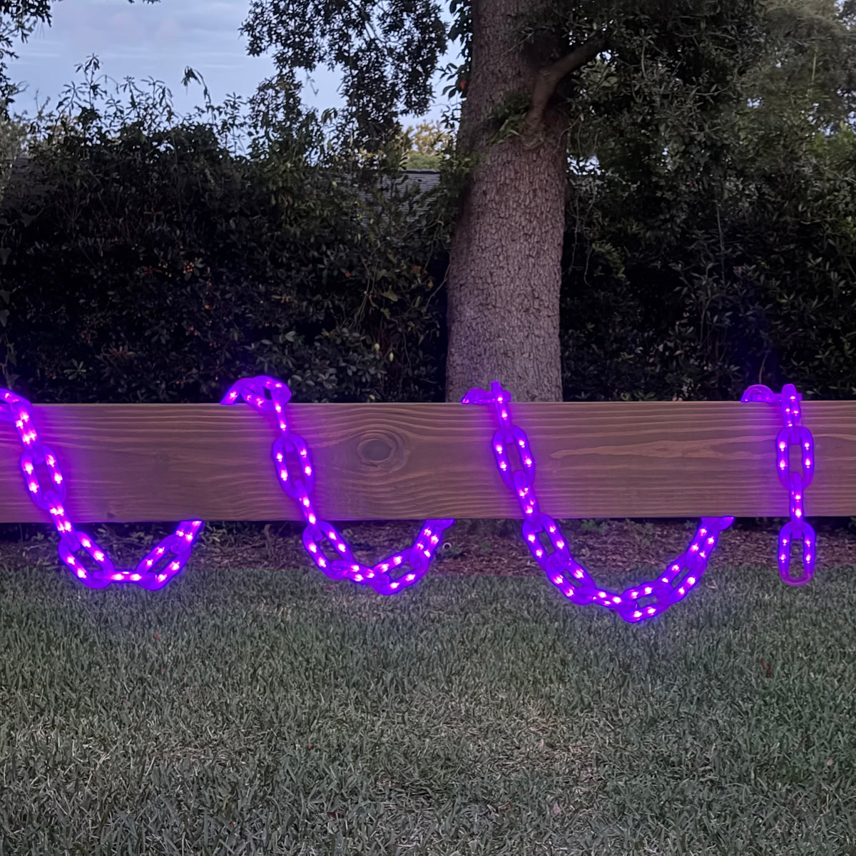 Purple String of Chains Lights illuminated and wrapped around a centerboard
