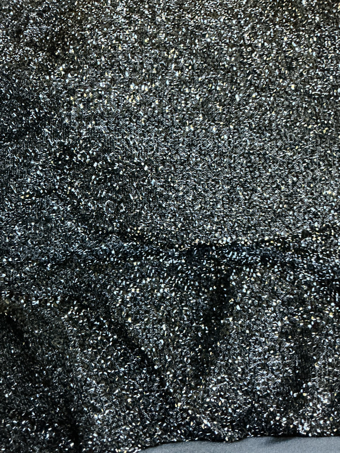 Actual black metallic shimmer chair cover fabric texture close-up