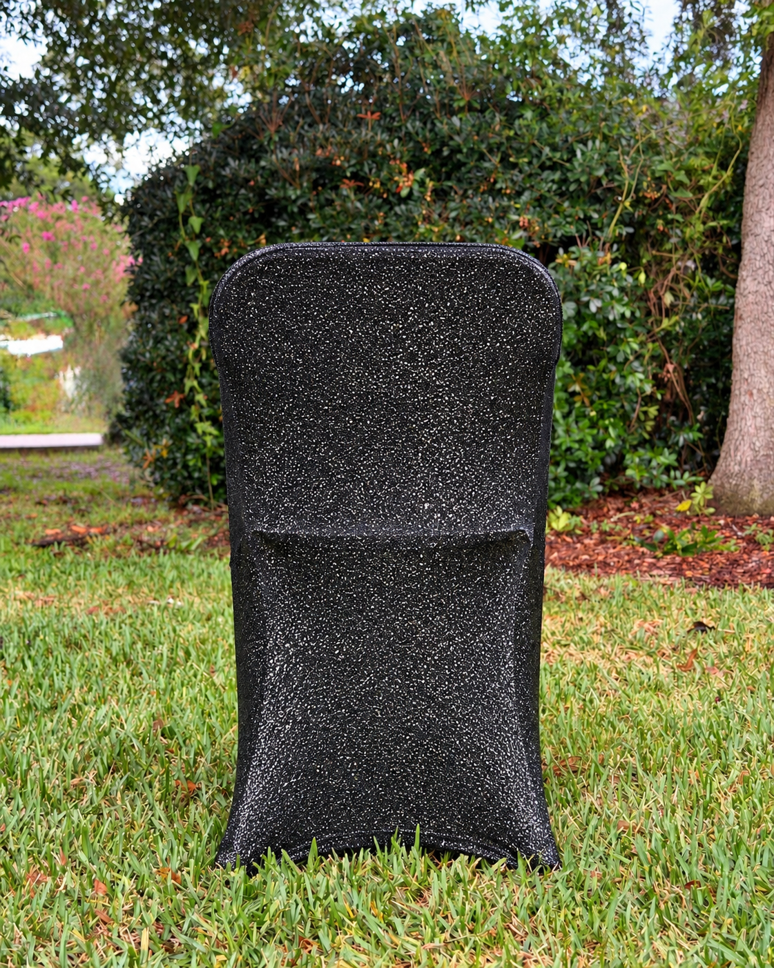Black metallic shimmer fitted folding chair cover in outdoor yard setting