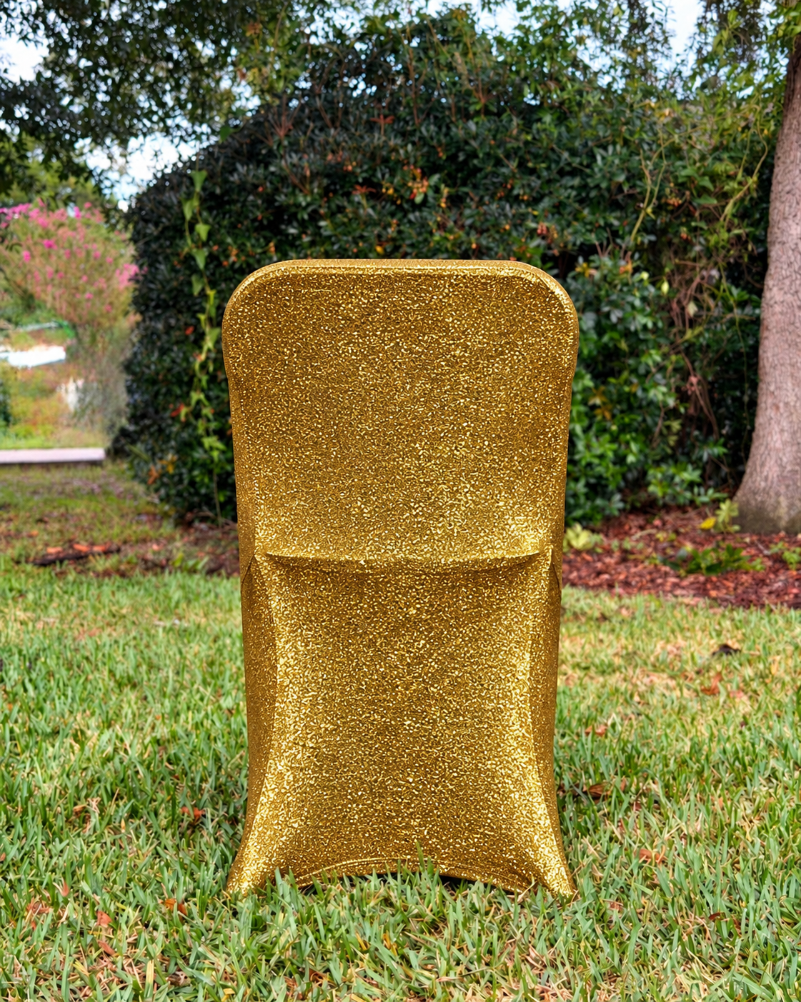 Gold metallic shimmer fitted folding chair cover in outdoor yard setting