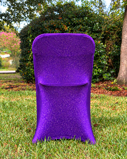 Purple metallic shimmer chair cover on a grassy lawn (styled product illustration)
