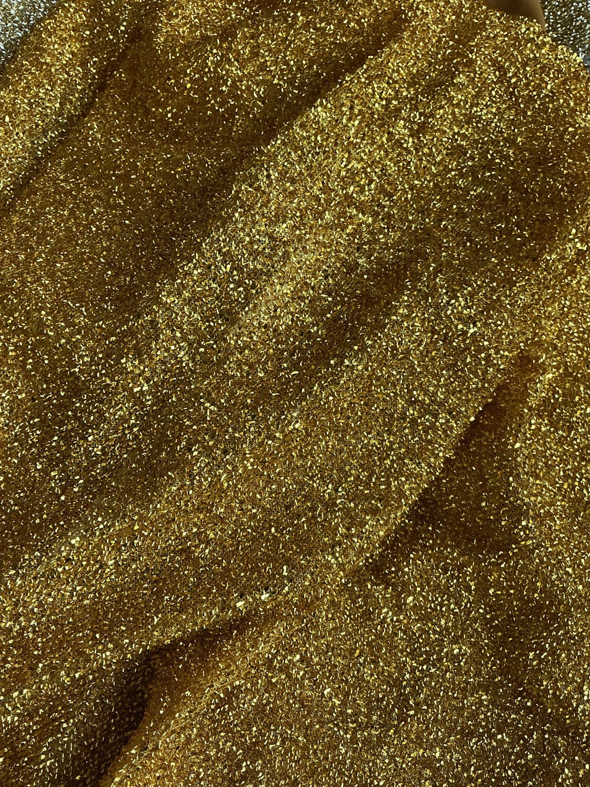 Actual gold metallic shimmer chair cover fabric texture close-up
