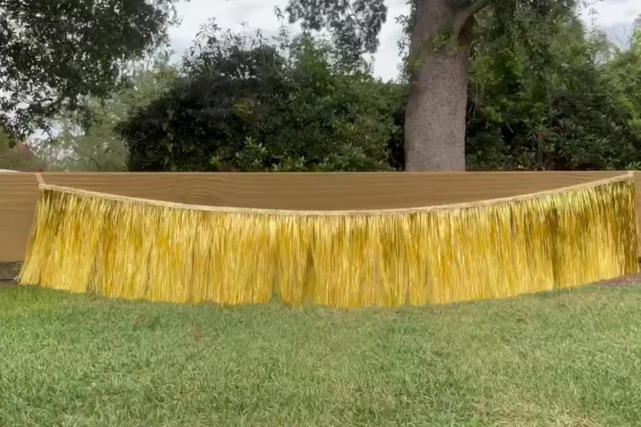 Gold, metallic, tinsel, fringe banner blowing in the wind video