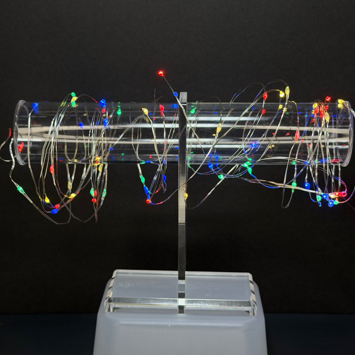 Multicolor RGB fairy lights displayed on clear stand
