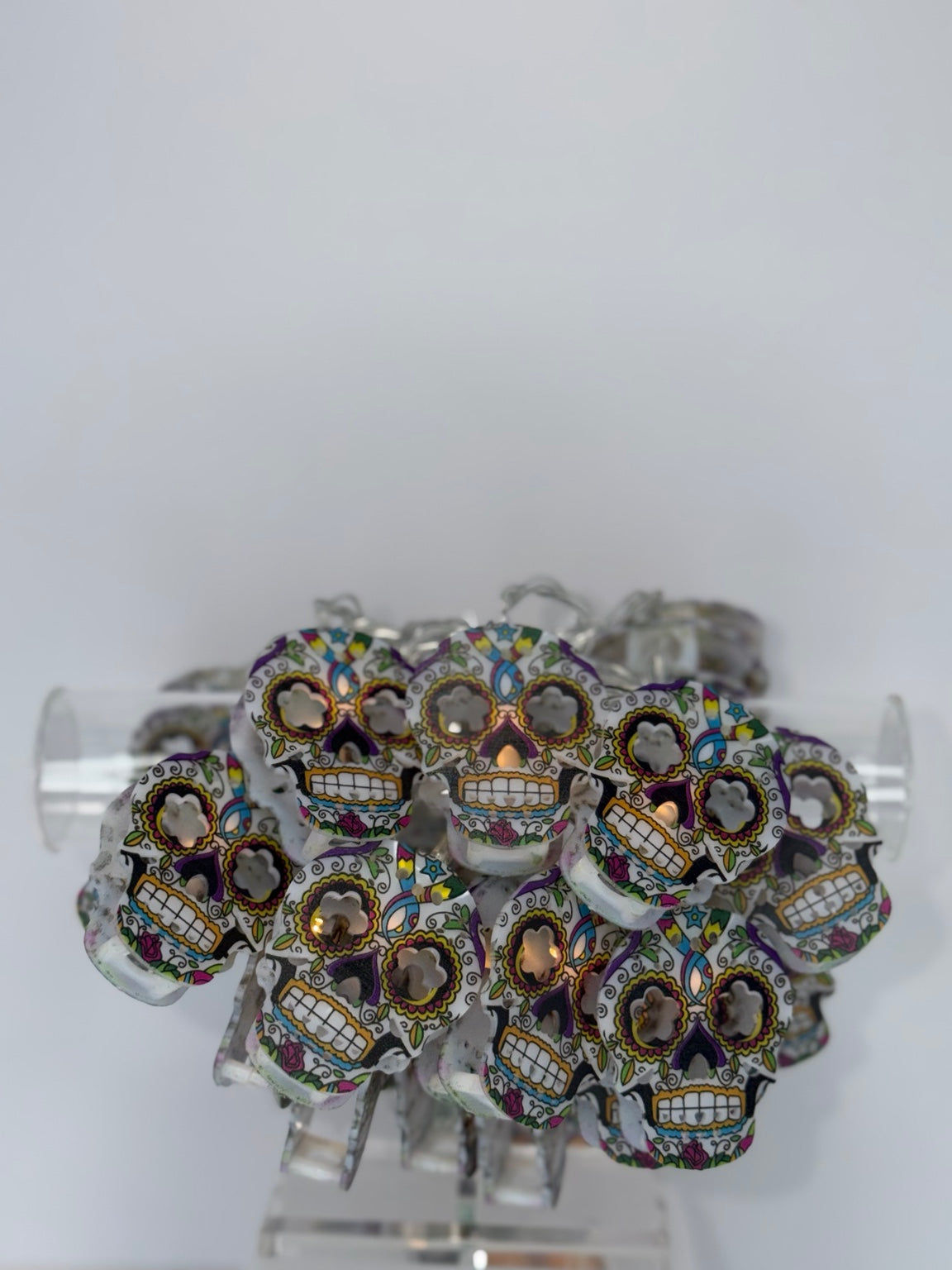 Colorful sugar skull string lights close-up, softly illuminated